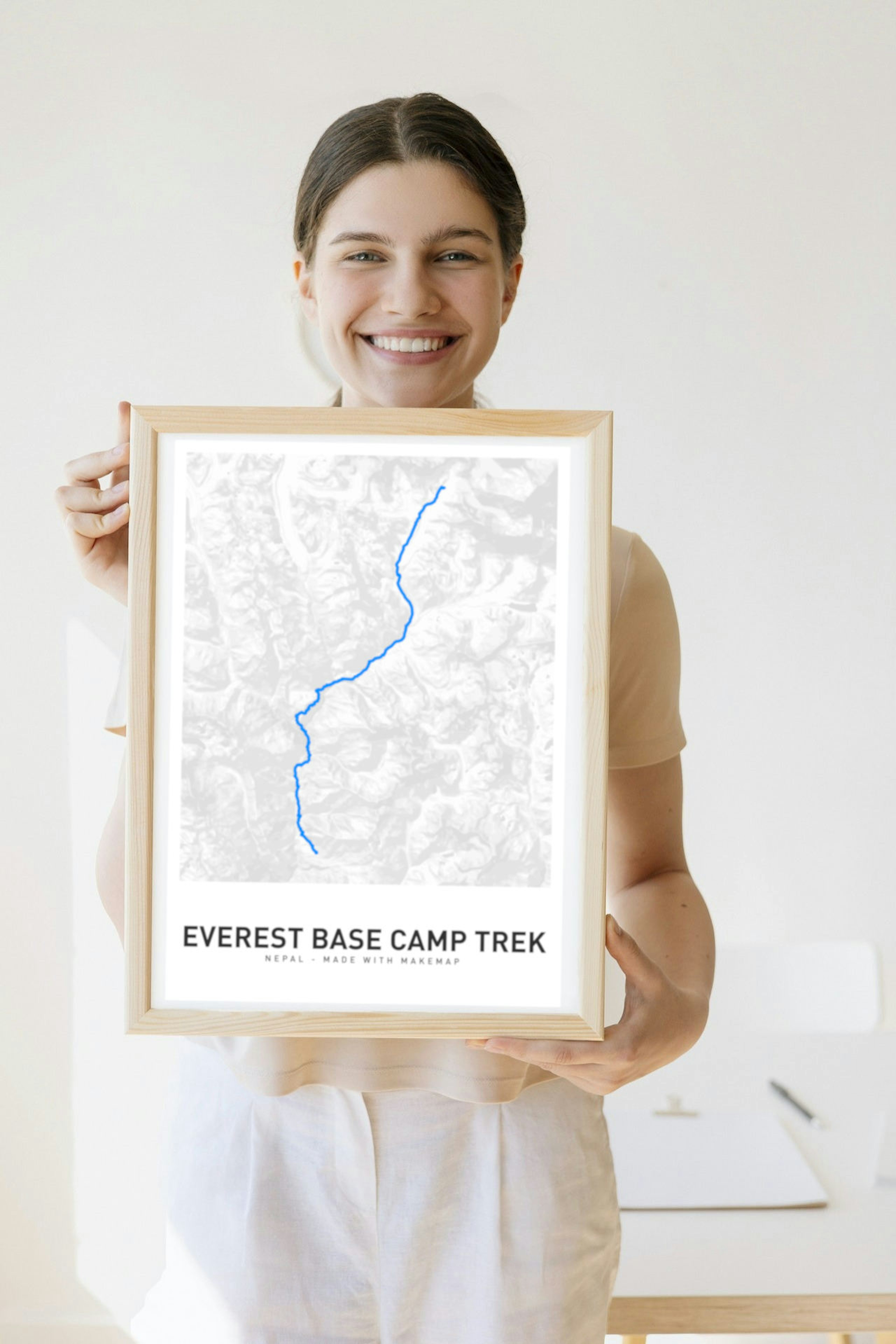 A customer holding her custom map poster